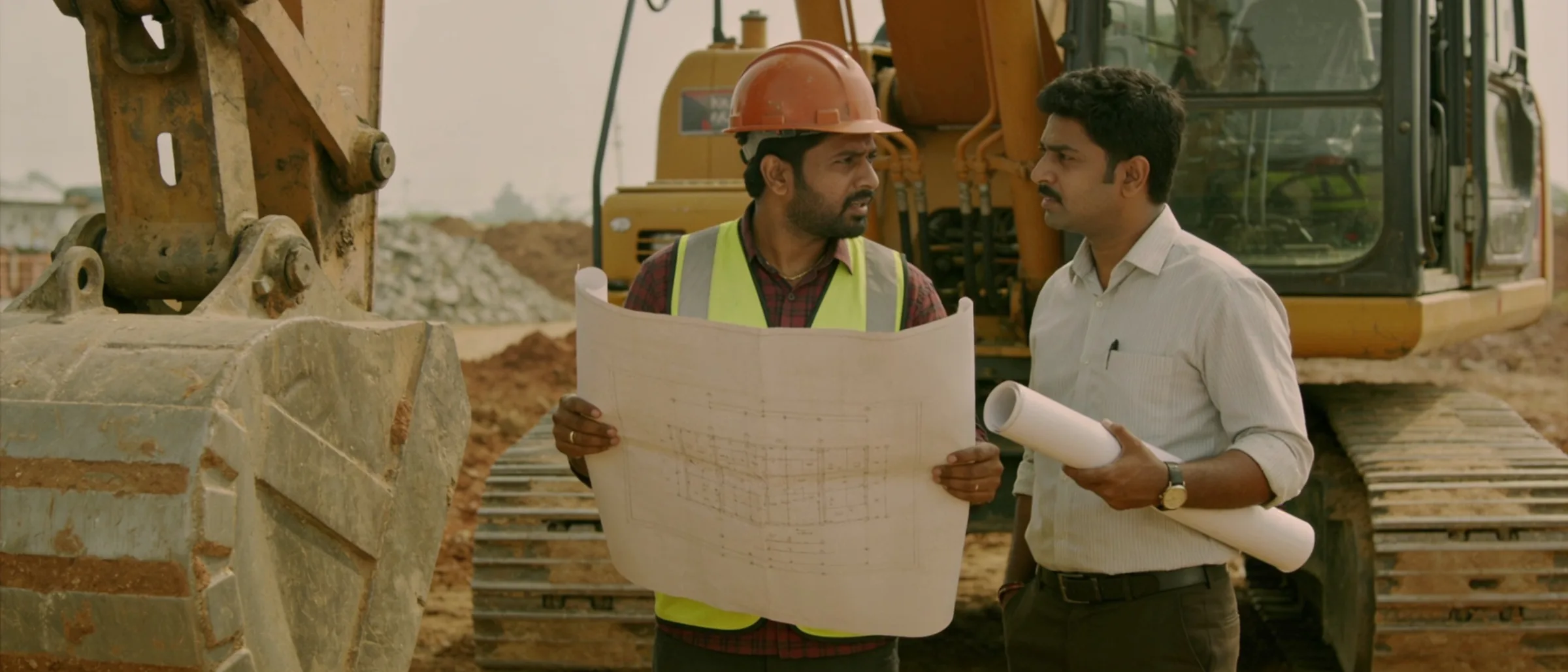 Operator and site engineer discussing the day's work plan beside the machine